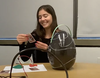 Child testing the cards with the egg