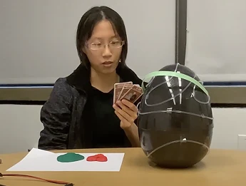 Child testing the cards with the egg